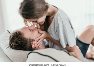 affectionate-couple-lying-on-couch-260nw-1345873604