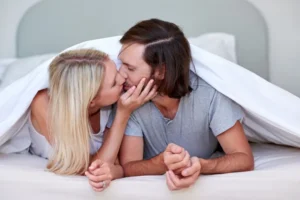 depositphotos_82161752-stock-photo-couple-kissing-under-duvet